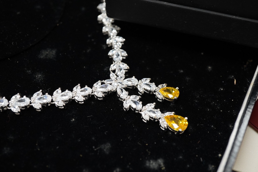 A collection of silver and other costume jewellery, including a diamond cluster ring in 9ct gold, size M, British hallmarks; a citrine ring in 9ct gold, size O, British hallmarks; a citrine ring in low carat gold, size N